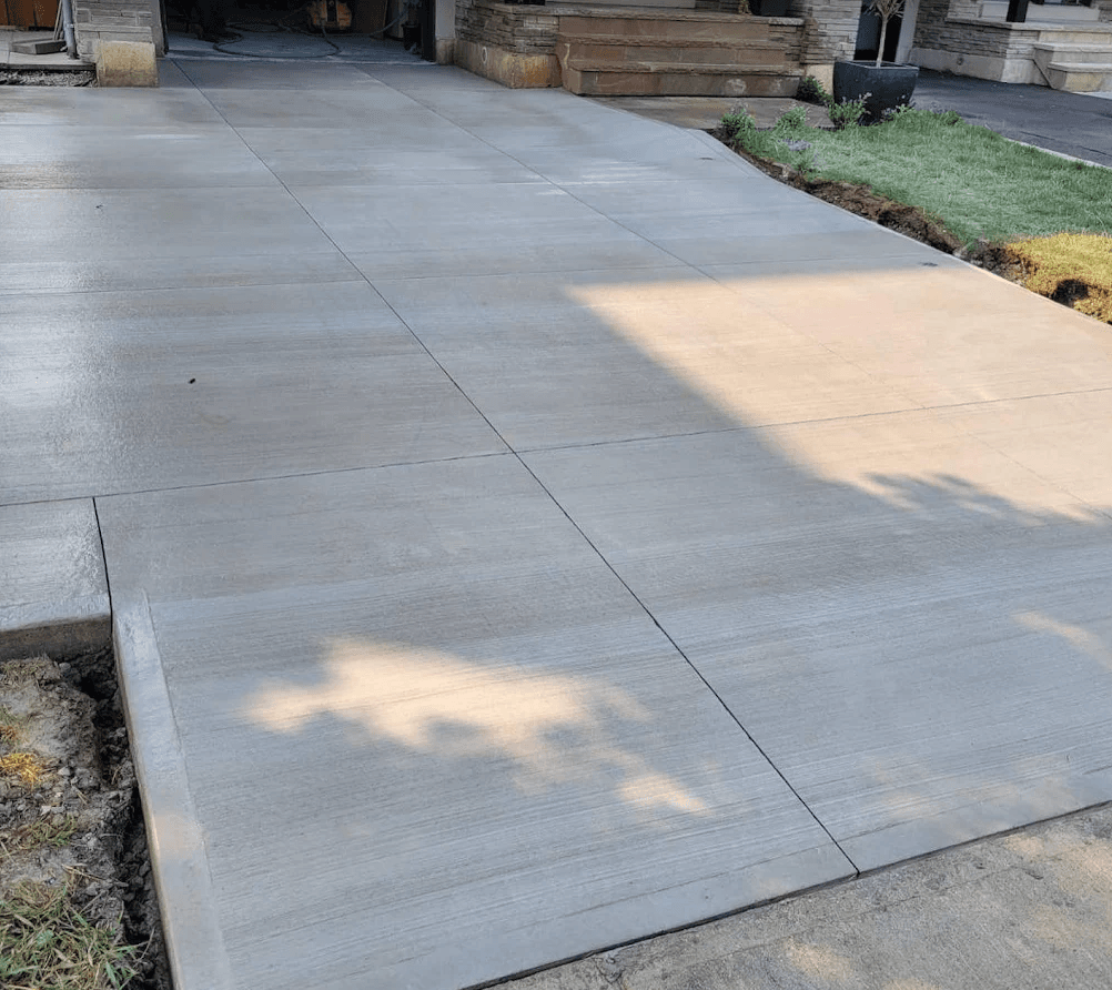 Freshly poured concrete driveway with clean control joints